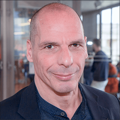 Headshot of Yanis Varoufakis. Full coour image with Yanis looking directly at the camera smiling naturally